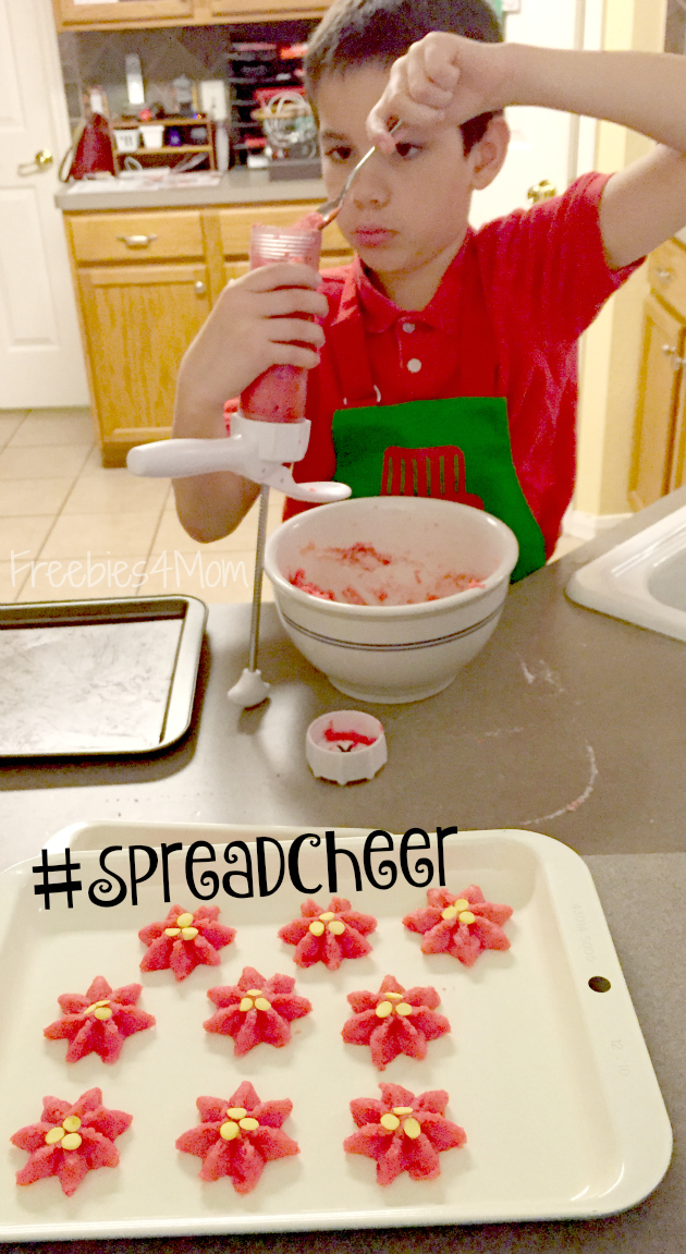 Using cookie press for Poinsetta Cookies to #SpreadCheer